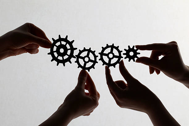 istock Silhouette of hands holding cogs and gears 171273318