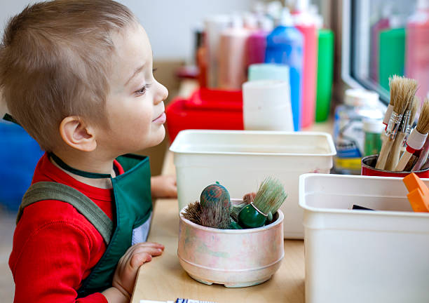 istock Little boy getting ready for painting in workshop. 171273685