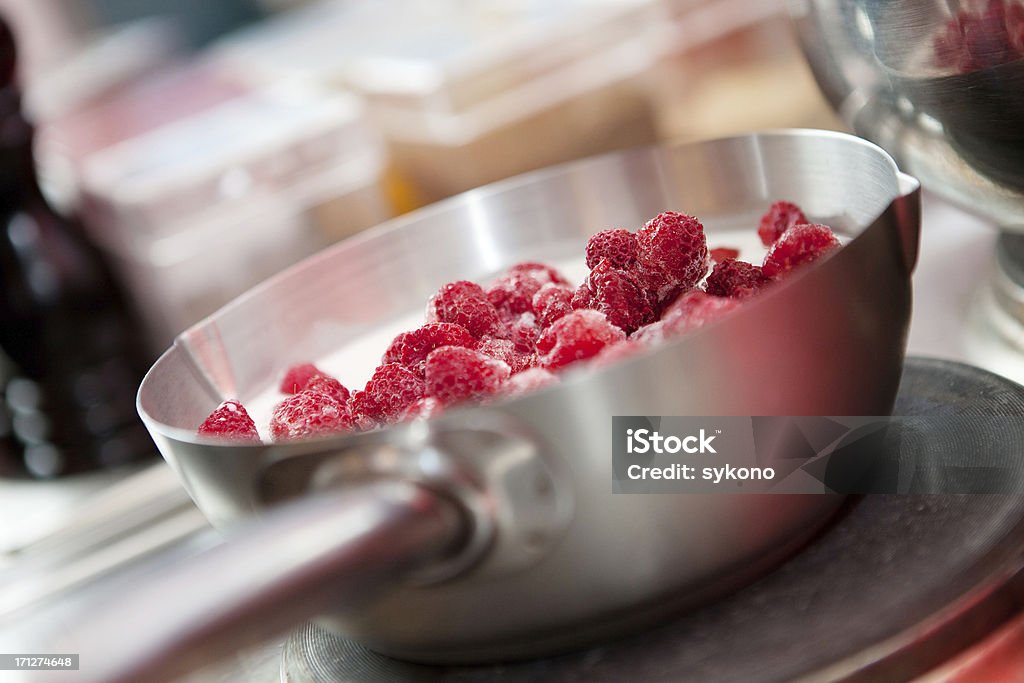 Preparing raspberry dessert Preparing  raspberry dessert in saucepan. Restaurant kitchen Cooking Pan Stock Photo