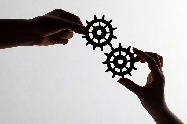istock Silhouette of hands holding cogs and gears 171274694
