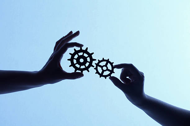 istock Silhouette of hands holding cogs and gears 171274698