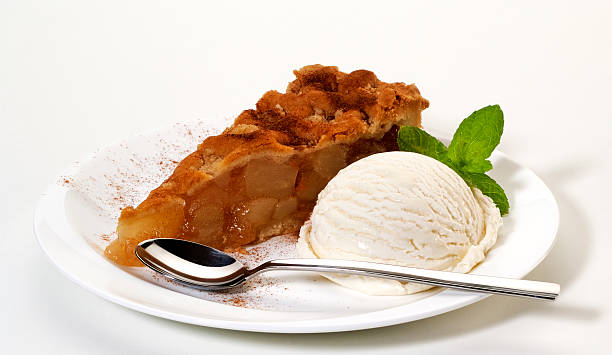 Apple pie with ice cream "Apple pie with a scoop of vanilla ice cream,cinnamon sprinkles and mint" apple pie and ice cream stock pictures, royalty-free photos & images