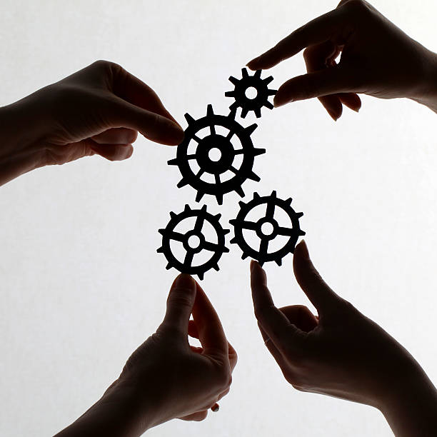 istock Silhouette of hands holding cogs and gears 171275464