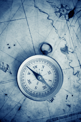 Compass on map. Finding direction concept.