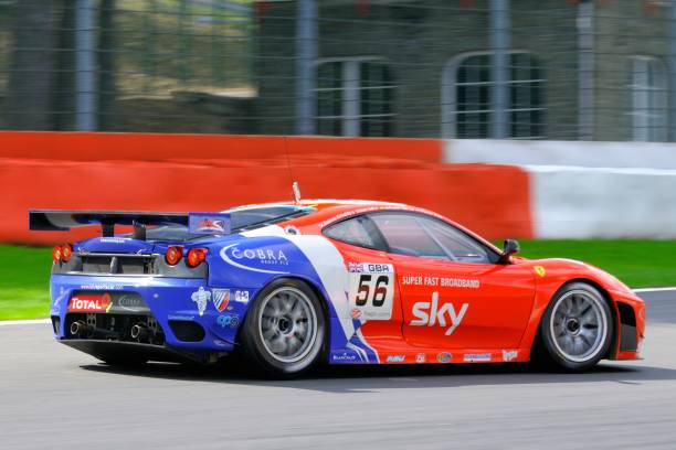 Ferrari F430 GT race car at the race track "Spa, Belgium - July 25, 2009: CRS Racing Ferrari F430 GT2 driving at Spa Francorchamps during the 2009 edition of the 24 Hours of Spa race." ferrari ferrari f430 italian culture action stock pictures, royalty-free photos & images