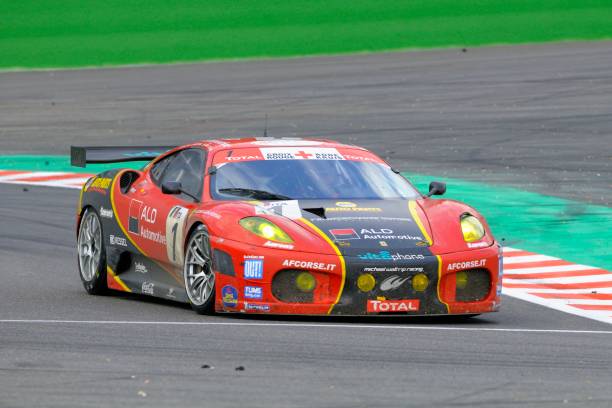 Ferrari F430 GT race car at the race track "Spa, Belgium - August 1, 2010: AF Corse Ferrari F430 racing on the track of Spa Francorchamps during the 2010 24 hours of Spa." ferrari ferrari f430 italian culture action stock pictures, royalty-free photos & images