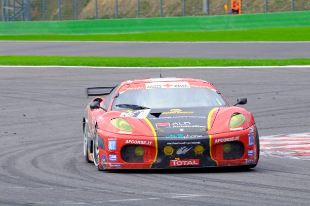 Ferrari F430 GT race car at the race track "Spa, Belgium - August 1, 2010: AF Corse Ferrari F430 racing on the track of Spa Francorchamps during the 2010 24 hours of Spa." ferrari ferrari f430 italian culture action stock pictures, royalty-free photos & images