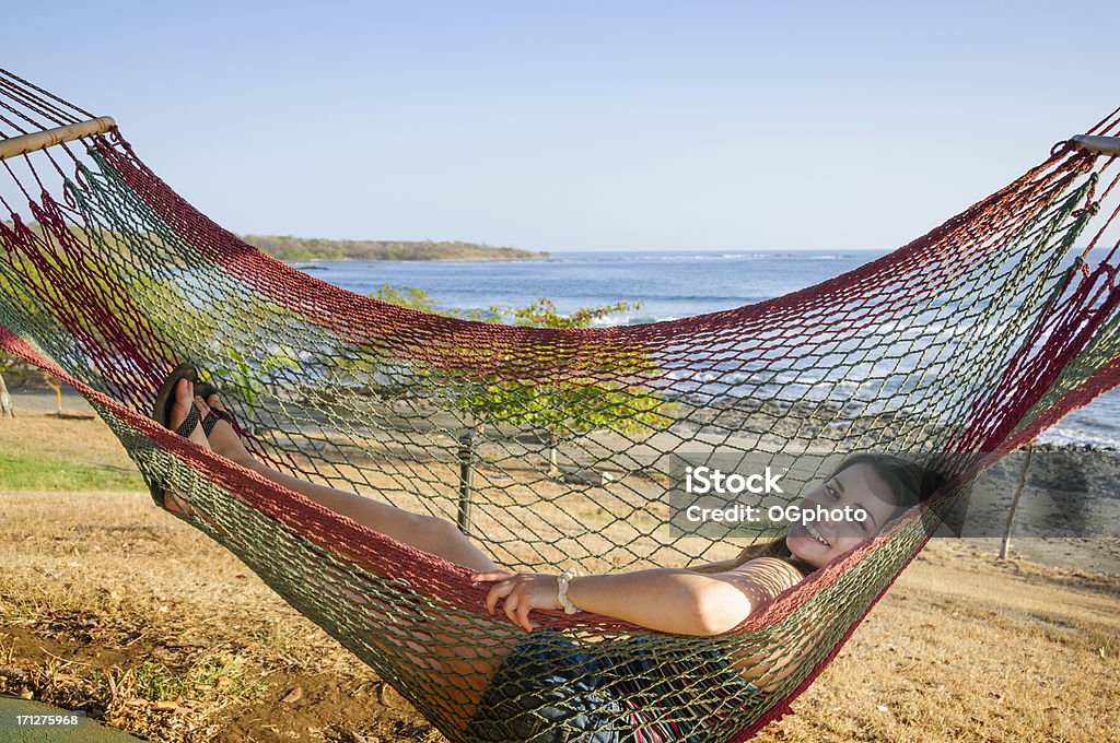 Teen girl relaxing in hammock Teen girl relaxing in a hammock while on vacation in Costa Rica. Hammock Stock Photo