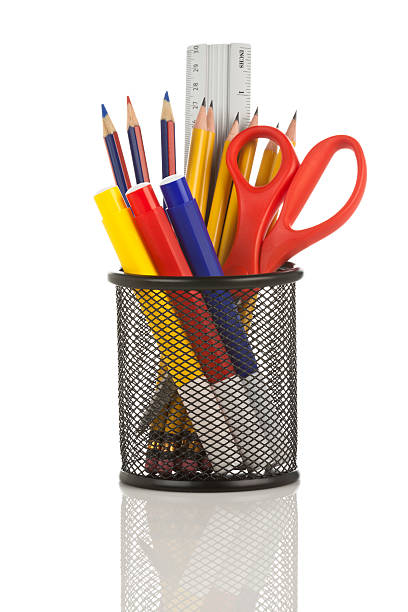 istock Desk organizer filled with some school supplies on white backdrop 171276333
