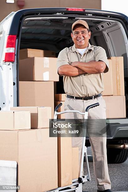 Hispanic Man Delivering Packages Stock Photo - Download Image Now - Parking Lot, Box - Container, Delivery Person