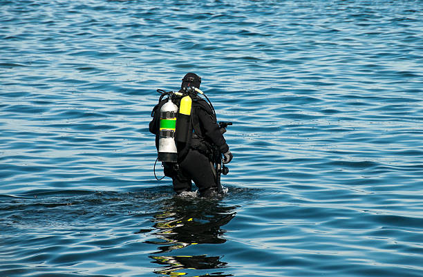 istock Scuba diver wading into Puget Sound with underwater camera 171276660