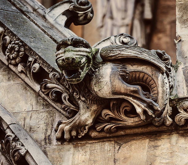 A photograph of a grotesque situated on Lichfield Cathedral in Lichfield, England.  The photographs of these grotesques form part of a series.  These sculptures are grotesques rather than gargoyles as gargoyles are intended to be part of the water drainage system from the rooftops of churches and cathedrals. It is not known what purpose the 'grotesques' serve but they certainly get ones imagination going. Some have amusing expressions whilst others are quite hideous.