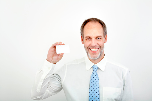 Mature business man holding a blanc credit card