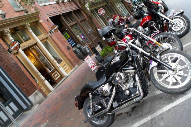 Harley Davidson Motorcycles Parked in Front of Dealership "Nashville, USA - May 4, 2012: Harley Davidson motorcycles lined up and parked on a downtown street in Nashville, Tennessee in front of the local Harley Davidson Motorcycle Dealership. Harley Davidson is an American motorcycle manufacturing company with dealers around the world." tennessee road sign stock pictures, royalty-free photos & images
