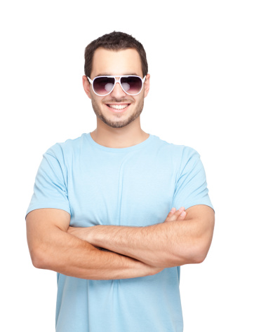 A smiling teenage boy wearing sunglasses isolated over white background.