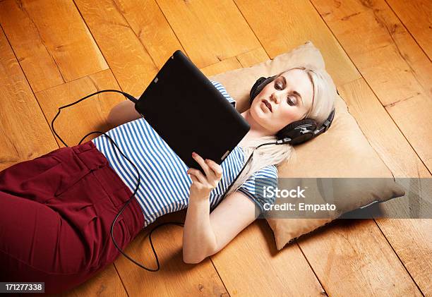 Mädchen Musik Hören Auf Elektronische Tablet Stockfoto und mehr Bilder von Holzboden - Holzboden, Kopfhörer, Liegen