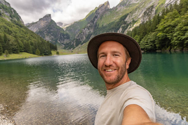 istock Man taking selfies in nature during summer vacation 1712777255
