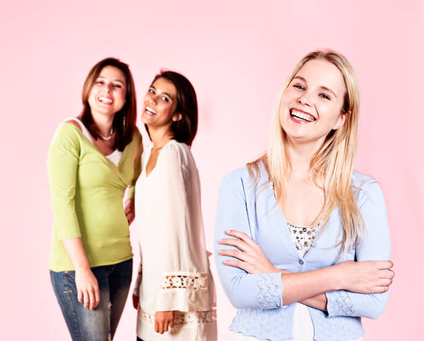 istock Three pretty women laughing against pink 171277897