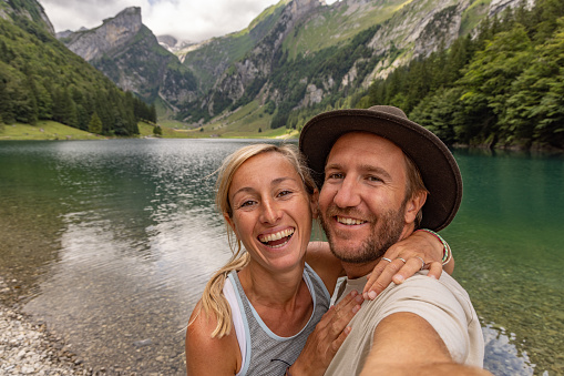 Couple taking selfies in nature during a summer vacation