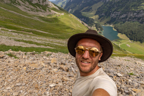 istock Man on a hike takes a selfie 1712782067