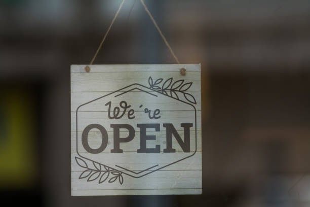 istock Open Sign at a Local Business Store - Welcoming Customers 1712784855