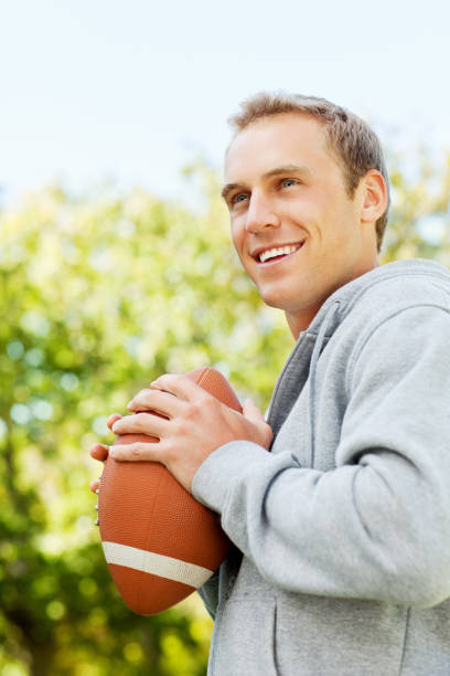 istock Young Man Holding American Football 171279000