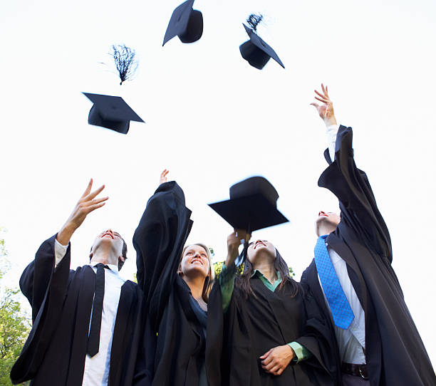 istock Group Of Students Attending Graduation Ceremony throwing Mortar 171279452