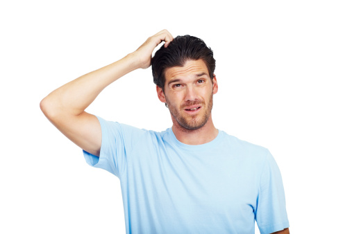 Man scratching his head while looking up with a confused expression on his face