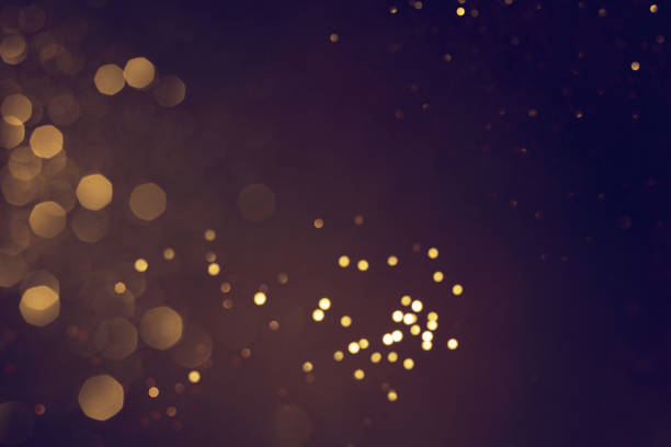 istock Golden abstract bokeh on black background. 1712797909