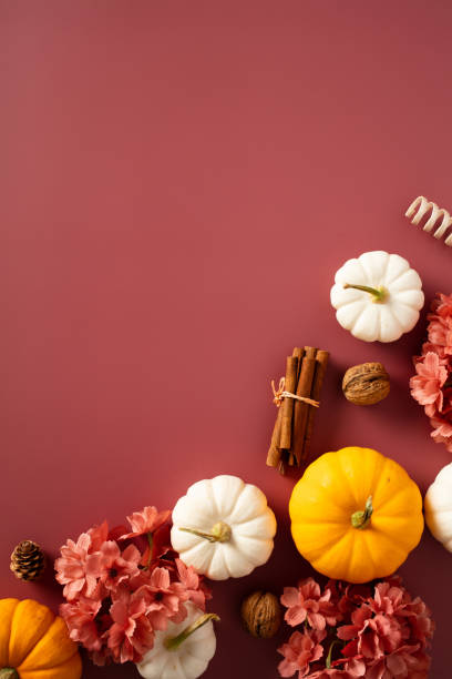 istock Dark red table with orange pumpkins, flowers, fall decor. Autumn background 1712798953