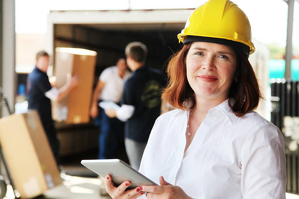 istock Forewoman with Tablet and Workers Loading Moving Truck 171280259