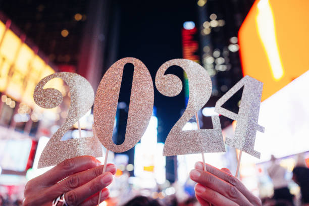 2024 New Year celebrations in Times Square, New York People hold the number 2024, celebration conceptual image for New Year’s Eve. times square new years eve stock pictures, royalty-free photos & images