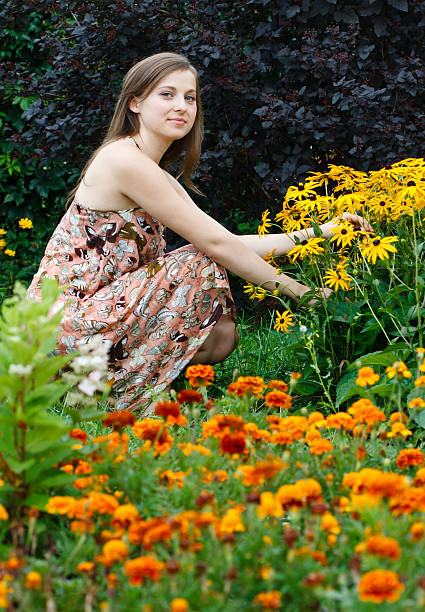 istock Young woman gardening 171280612