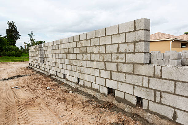 Construction: Concrete block Wall The first wall of a new house constructed out of concrete block Building and Construction jodijacobson stock pictures, royalty-free photos & images