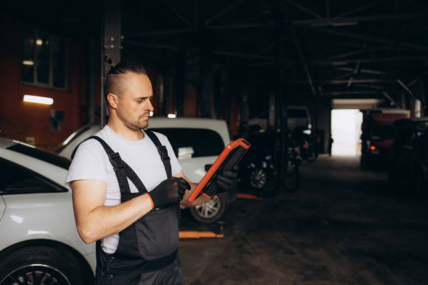 istock Mechanic using tablet on car at the repair garage 1712808154