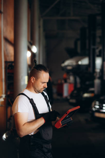istock Happy mechanic using digital tablet at auto repair shop. 1712808169