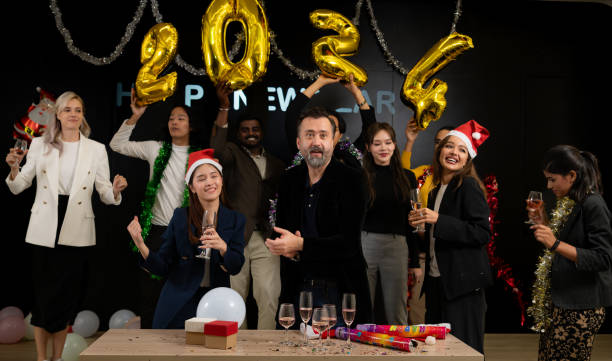 Merry Christmas and Happy New Year! Cheerful multiethnic friends in Santa hats having fun and drinking champagne at party. Merry Christmas and Happy New Year! Cheerful multiethnic friends in Santa hats having fun and drinking champagne at party.  Spotify Completed   New Year  Party stock pictures, royalty-free photos & images