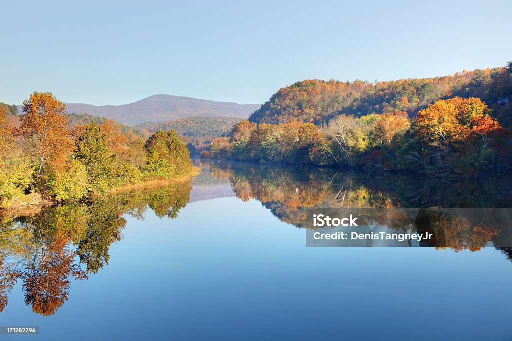 Blue Ridge Mountains in Autumn Early morning light reflecting  beautiful fall colors on the James River along the Blue Ridge Parkway in Virginia. Autumn foliage  along Blue Ridge Parkway and Blue Ridge Mountains of Virginia make the region one of the most beautiful places in the world.  Blue Ridge Parkway Stock Photo