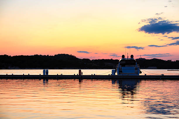 Horizontal image of the silhouette of the nautical vessel with dramatic sky during the evening.
