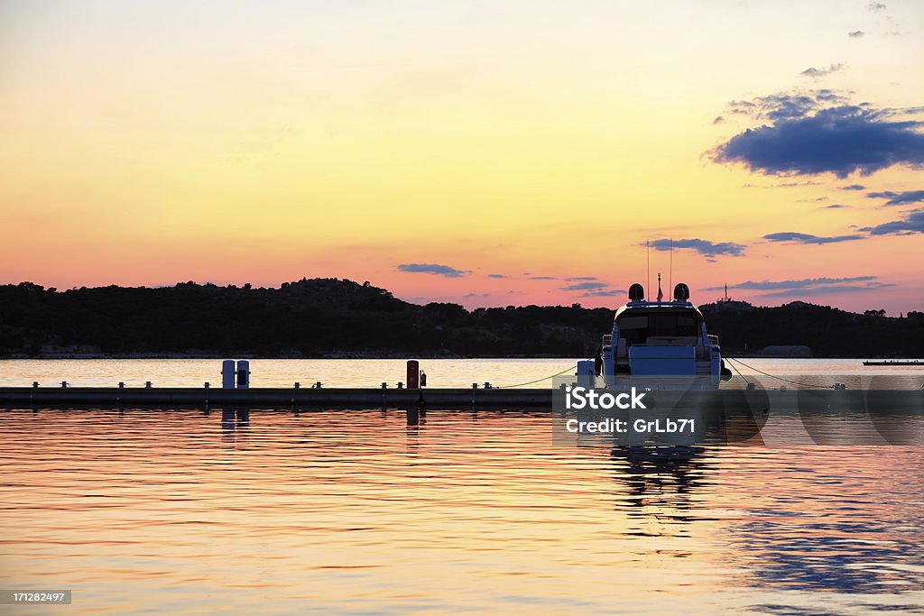 Silhuette of the sailing boat during evening Horizontal image of the silhouette of the nautical vessel with dramatic sky during the evening. Adriatic Sea Stock Photo