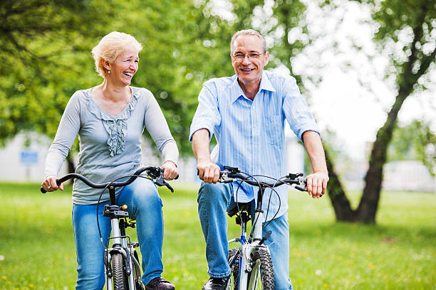 istock Cheerful mature couple riding bicycles in park. 171282538