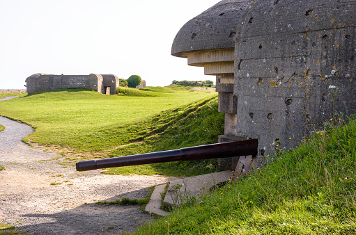 Longues-sur-Mer, France - Sept. 5, 2023: Two bunkers holding a 150 mm gun in the Longues-sur-Mer battery in Normandy, a WWII German coastal artillery battery part of the Atlantic Wall fortifications.