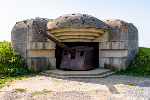 Longues-sur-Mer, France - Sept. 5, 2023: A bunker holding a 150 mm gun in the Longues-sur-Mer battery in Normandy, a WWII German coastal artillery battery part of the Atlantic Wall fortifications.