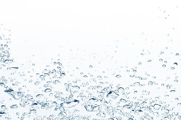 Blue air bubbles rising in clear fresh water stock photo
