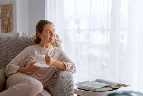 istock woman enjoying book and tea 1712831743