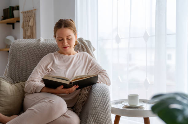 istock woman enjoying book and tea 1712831767