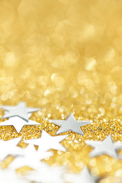istock silver stars on golden glittering background 171285179