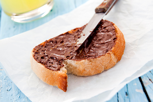 Chocolate hazelnut spread on a slice of bread
