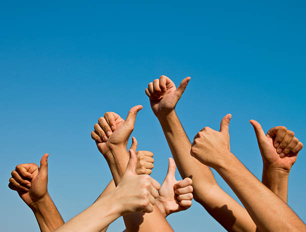istock Group of hands giving thumbs up over blue sky 171285444