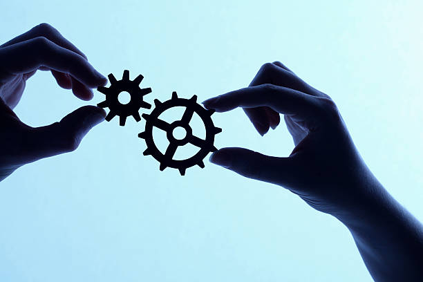 istock Silhouette of hands holding cogs and gears 171285505